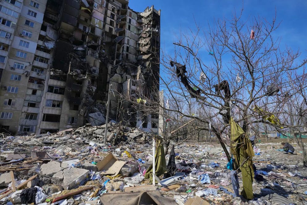 Clothes thrown by the Russian shelling from the ruined house hang on a tree in Kharkiv, Ukraine, Saturday, March 26, 2022. (AP Photo/Efrem Lukatsky)