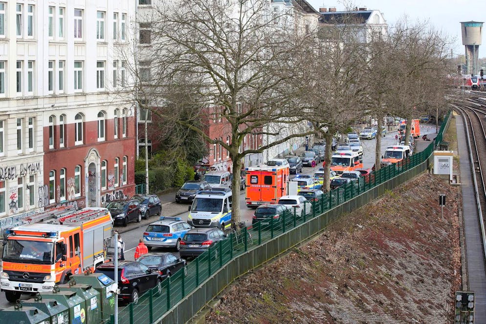 05.04.2022, Hamburg: Einsatzwagen der Polizei und der Feuerwehr stehen an einer von mehreren gesperrten Straßen im Stadtteil Altona. In einem Haus nahe dem Bahnhof Hamburg-Altona sind am Dienstagmorgen Schüsse gefallen. Die Polizei fand zwei leblose Personen. Es gebe keine weiteren Beteiligten, sagte die Polizei. Sie geht darum von einem sogenannten erweiterten Suizid aus. Foto: Bodo Marks/dpa +++ dpa-Bildfunk +++ (KEYSTONE/DPA/Bodo Marks)