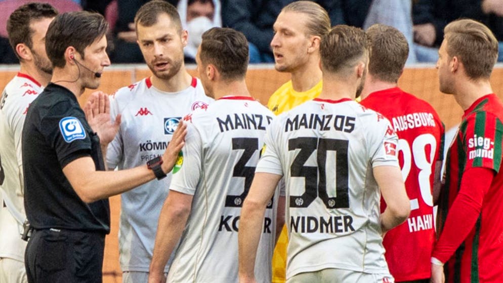 Die Spieler von Mainz diskutieren heftig mit Schiedsrichter Matthias Jöllenbeck.