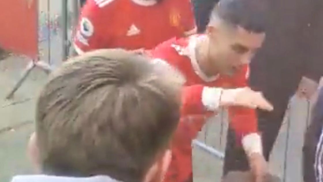 Freak out with consequences?.  Ronaldo smacks the phone out of a young fan’s hand.