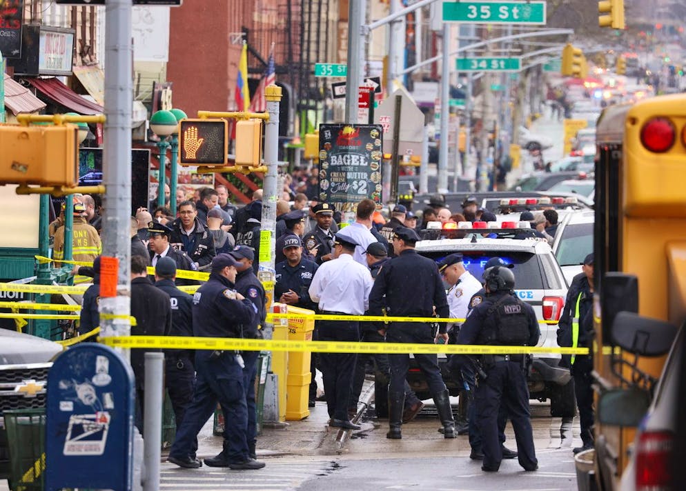 epa09885981 New York City Police and Fire Department officials on the scene of a reported multiple shooting at a New York City Subway station in the Brooklyn borough of New York, New York, USA, 12 April 2022. EPA/JUSTIN LANE
