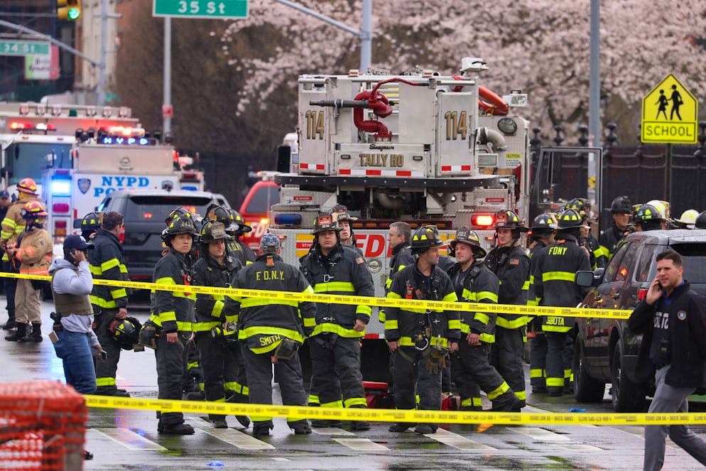 epa09885985 New York City Police and Fire Department officials on the scene of a reported multiple shooting at a New York City Subway station in the Brooklyn borough of New York, New York, USA, 12 April 2022. EPA/JUSTIN LANE