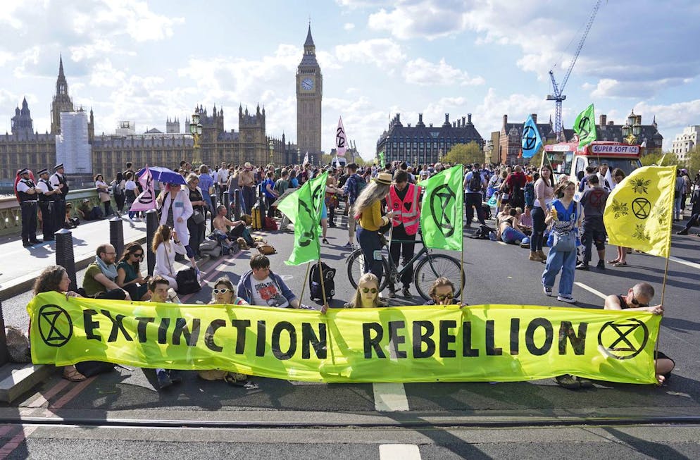 On Friday, April 15, 2022, protesters take part in a devastating uprising on Westminster Bridge in London.  Protesters have blocked four London bridges and disrupted traffic.  Cars and red double-decker buses lined the roads as hundreds of Extinction rebel activists called for an end to London's Waterloo, Blackfriars, Lambert and Westminster bridges and new fossil fuel investments.  (Stephen Rousseau / PA via Abi)