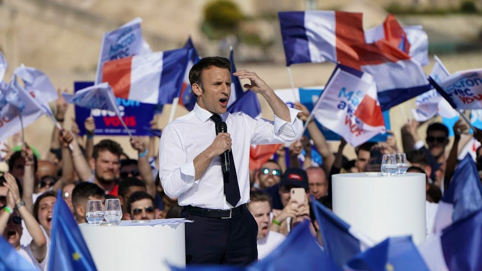 French President and centrist candidate Emmanuel Macron, left, speaks during a campaign rally, Saturday, April 16, 2022 in Marseille, southern France. Far-right leader Marine Le Pen is trying to unseat centrist President Emmanuel Macron, who has a slim lead in polls ahead of France's April 24 presidential runoff election. (AP Photo/Laurent Cipriani)