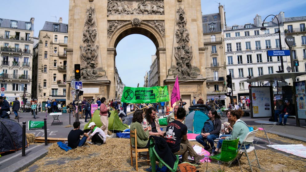 The environmental group Extinction Rebellion takes part of a three-day demonstration against what they call France's inaction on climate issues, during an occupation in the district of Porte de Saint Denis in the center of Paris, France, Monday, April 18, 2022. The activists say their objective is