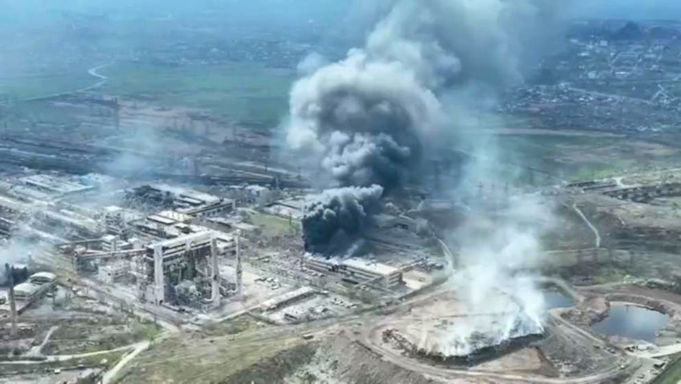 epa09896967 A frame grab from an undated handout drone video first published by DPR militia commander Alexander Khodakovsky and made available by the Mariupol City Council shows smoke rising from the Azovstal steel plant during airstrikes in Mariupol, eastern Ukraine, 18 April (issued 19 April 2022). The Russian Defence Ministry on 19 April 2022 issued a statement calling on the Ukrainian forces in Mariupol