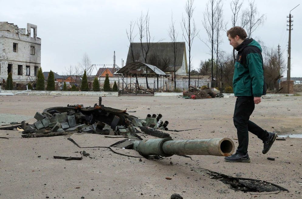 epa09886379 A man looks on the debris of a destroyed Russian tank in Bohdanivka village, Kyiv area, Ukraine, 12 April 2022. Some cities and villages have recently been recaptured by the Ukrainian army from Russian forces withdrawing, and now people try to restore normal life there. On 24 February Russian troops had entered Ukrainian territory resulting in fighting and destruction in the country, a huge flow of refugees, and multiple sanctions against Russia. EPA/SERGEY DOLZHENKO