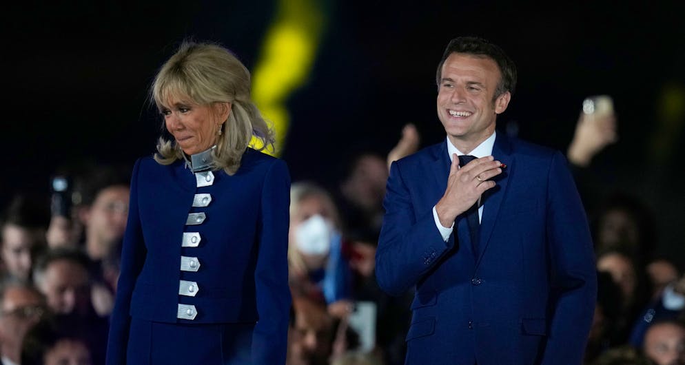 French President Emmanuel Macron and French first lady Brigitte Macron celebrate with supporters in Paris, France, Sunday, April 24, 2022. Polling agencies projected that French President Emmanuel Macron comfortably won reelection Sunday in the presidential runoff, offering French voters and the European Union the reassurance of leadership stability in the bloc's only nuclear-armed power as the continent grapples with Russia's invasion of Ukraine. (AP Photo/Christophe Ena)