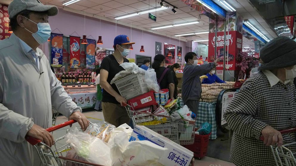 Residents wearing masks shop at a supermarket in the Chaoyang district of Beijing, Monday, April 25, 2022. Mass testing started Monday in Chaoyang district, home to more than 3 million people in the Chinese capital, following a fresh COVID-19 outbreak. (AP Photo/Ng Han Guan)