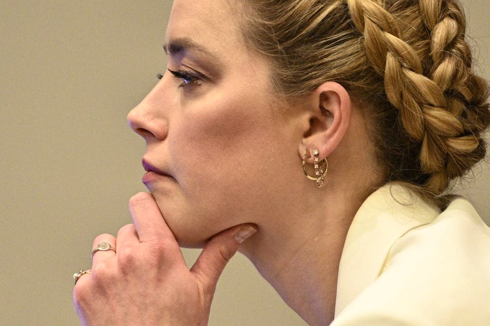 Actress Amber Heard listens during the trial at the Fairfax County Circuit Court in Fairfax, Va., Tuesday, April 26, 2022. Actor Johnny Depp sued his ex-wife actress Amber Heard for libel in Fairfax County Circuit Court after she wrote an op-ed piece in The Washington Post in 2018 referring to herself as a 