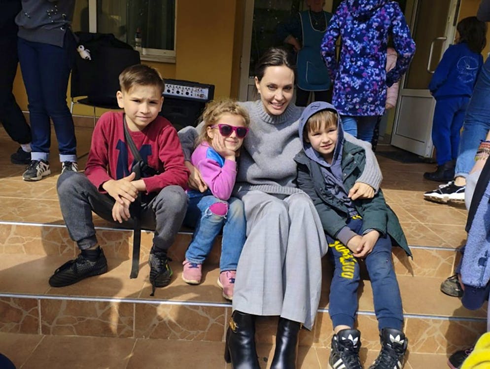 In this image provided by the Lviv city hall Angelina Jolie, Hollywood movie star and UNHCR goodwill ambassador, poses for photo with kids in Lviv, Ukraine, Saturday, Apr. 30, 2022. Ms Jolie was in Ukraine to meet the children affected by the war and visited hospitals and NGOs helping the injured and displaced. (Maksym Kozutsky/Lviv City Hall via AP)