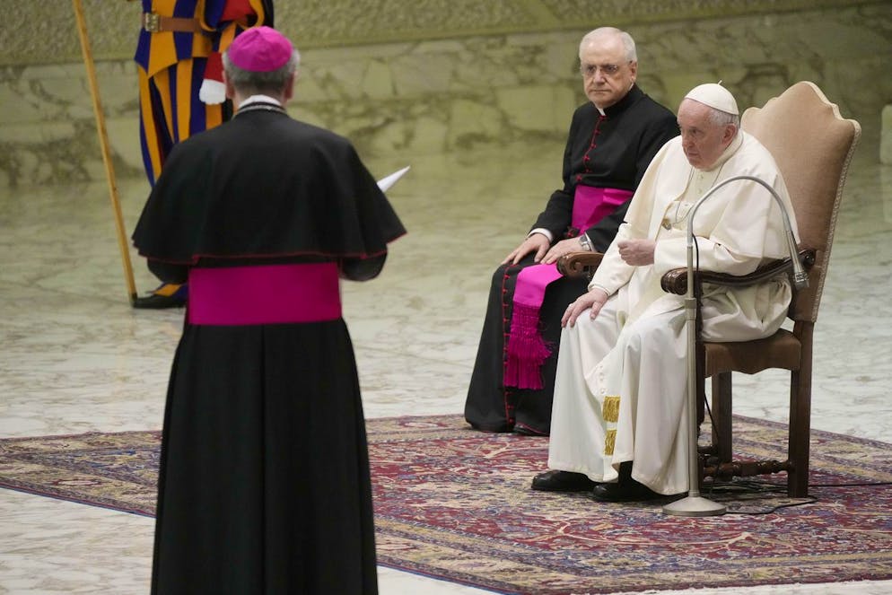 Pope Francis touches his right knee during an audience with Slovakian pilgrims in the Paul VI Hall at the Vatican, Saturday, April 30, 2022. (AP Photo/Gregorio Borgia)