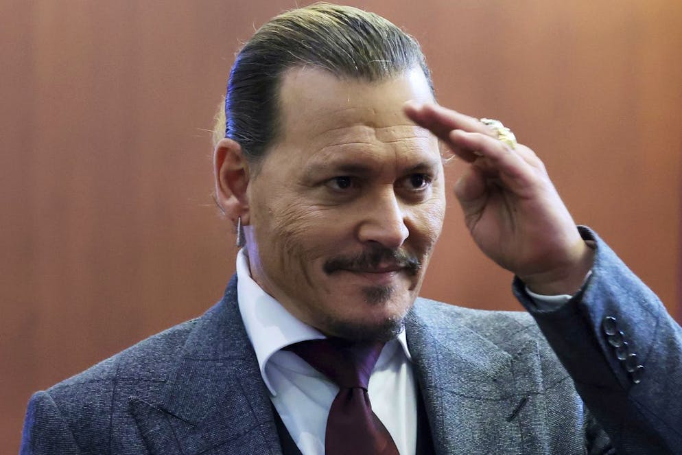 Actor Johnny Depp reacts to fans in the courtroom as court finishes for the day at the Fairfax County Circuit Court in Fairfax, Va., Thursday, April 28, 2022. Actor Johnny Depp sued his ex-wife actor Amber Heard for libel in Fairfax County Circuit Court after she wrote an op-ed piece in The Washington Post in 2018 referring to herself as a 