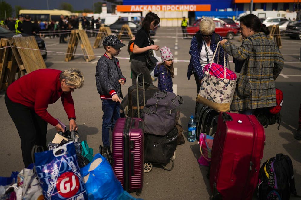 People arrive at a reception center for displaced people in Zaporizhzhia, Ukraine, Monday, May 2, 2022. Thousands of Ukrainian continue to leave Russian occupied areas. (AP Photo/Francisco Seco)