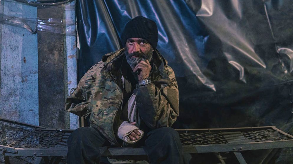 In this photo provided by Azov Special Forces Regiment of the Ukrainian National Guard Press Office, an Azov Special Forces Regiment's serviceman, injured during fighting against Russian forces, poses for a photographer inside the Azovstal steel plant in Mariupol, Ukraine, Tuesday, May 10, 2022. (Dmytro 'Orest' Kozatskyi/Azov Special Forces Regiment of the Ukrainian National Guard Press Office via AP)