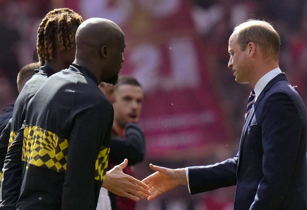 Prince William, right, shakes hands with Chelsea players before the English FA Cup final soccer match between Chelsea and Liverpool, at Wembley stadium, in London, Saturday, May 14, 2022. (AP Photo/Kirsty Wigglesworth)