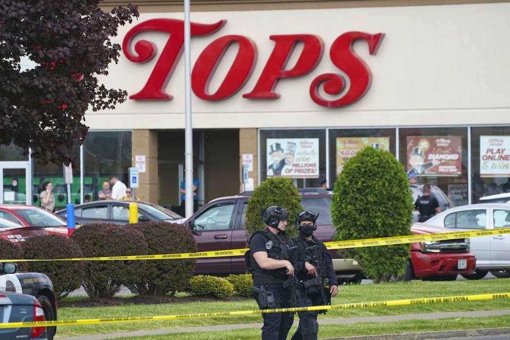Police secure an area around a supermarket where at least 10 people were killed in a shooting, Saturday, May 14, 2022 in Buffalo, N.Y. Officials said the gunman entered the supermarket with a rifle and opened fire. Investigators believe the man may have been livestreaming the shooting and were looking into whether he had posted a manifesto online (Derek Gee/The Buffalo News via AP)