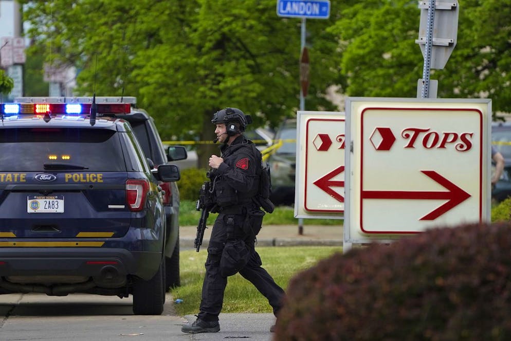 Police secure the area around a supermarket where several people were killed in a shooting, Saturday, May 14, 2022 in Buffalo, N.Y. Officials said the gunman entered the supermarket with a rifle and opened fire. Investigators believe the man may have been livestreaming the shooting and were looking into whether he had posted a manifesto online. (Mark Mulville/The Buffalo News via AP)