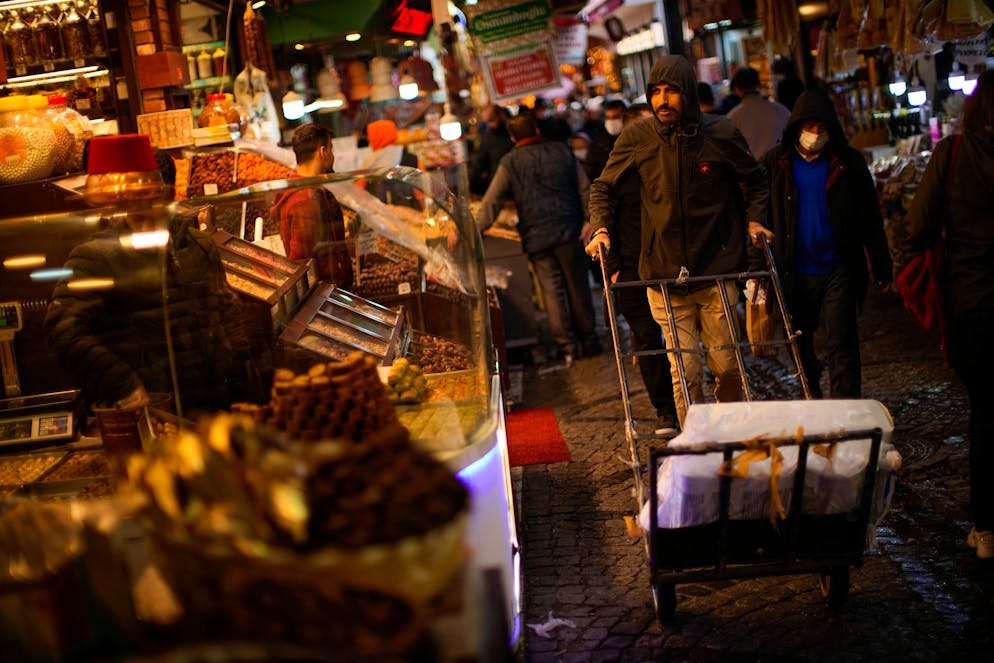 A man pushes a trolley with goods along a shops alley near the Egyptian bazaar in Istanbul, Turkey, Monday, April 11, 2022. Yearly inflation in Turkey hit 61.14% on April, climbing to a new 20-year high and deepening a cost of living crisis for many households. (AP Photo/Francisco Seco)