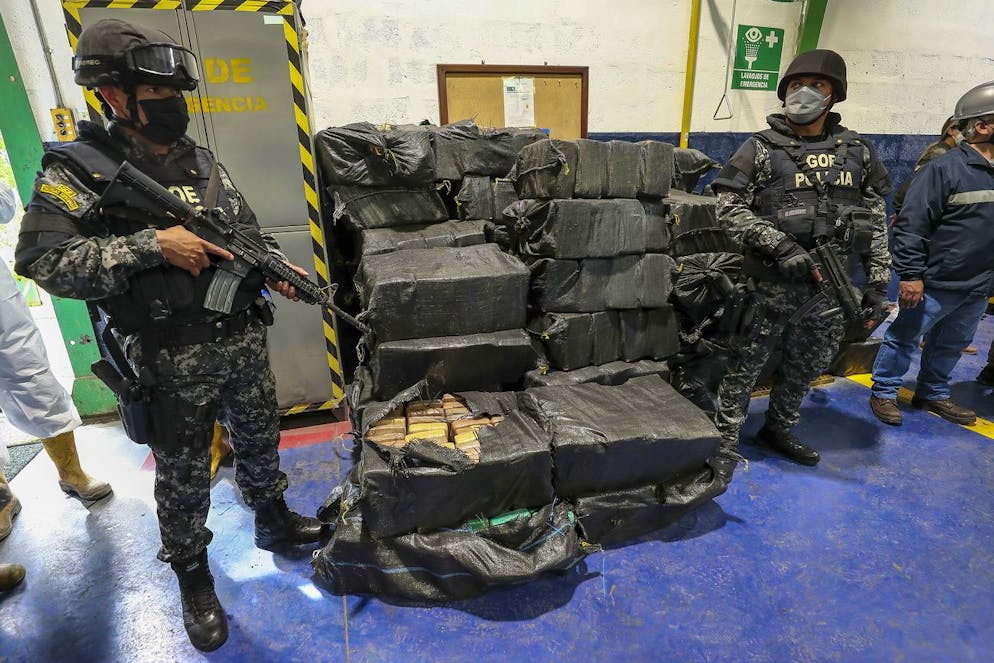 epa09901638 Ecuadorian police guard packages of drugs seized in several operations carried out months ago and that will now be destroyed, in the town of Cayambe, Ecuador, 21 April 2022. EPA/Jose Jacome