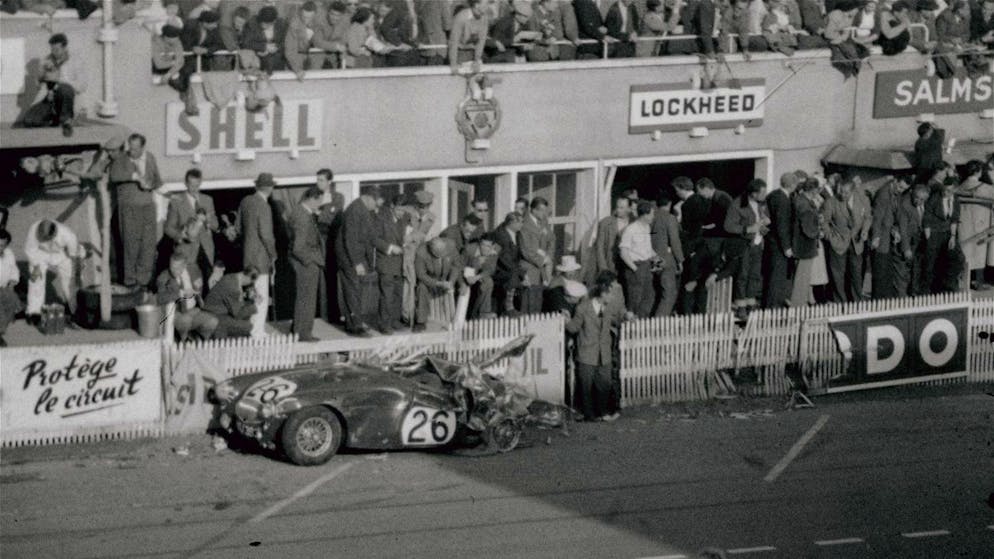 The Austin Healey, #26, into which French driver Pierre Levegh crashed lies in a mangled heap on the side of the track at Le Mans, June 11, 1955. Levegh's Mercedes 20 struck the Healy from behind and exploded in an enormous fireball, killing him and over 84 spectators. (AP Photo)