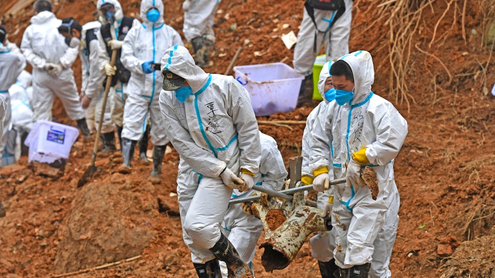 FILE - In this photo released by Xinhua News Agency, rescuers carry a piece of plane wreckage from the China Eastern flight crash site in Tengxian County, southern China's Guangxi Zhuang Autonomous Region, on March 25, 2022. Chinese officials said Thursday that the search for wreckage in last week's crash of a China Eastern Boeing 737-800 is basically done and that more than 49,000 pieces of debris had been found. (Zhou Hua/Xinhua via AP, File)