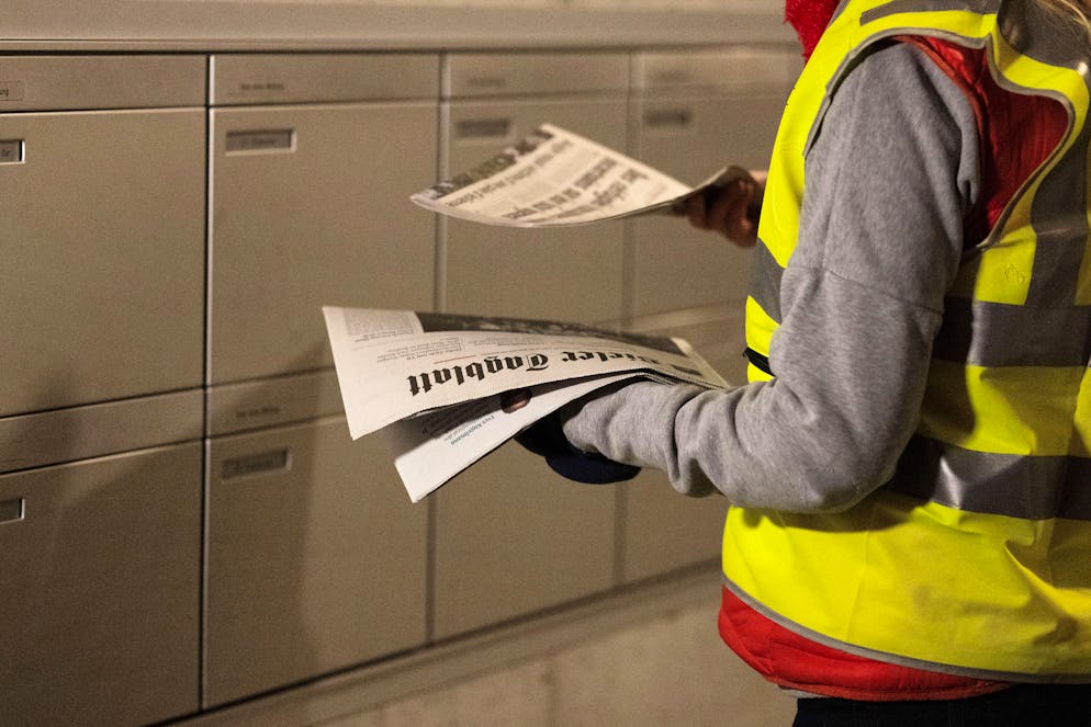 Fruehzustelldienst von Tageszeitungen durch eine Zeitungsaustraegerin der Presto Presse-Vertriebs AG, fruehmorgens am Mittwoch, 26. Januar 2022 in Biel. Die Presto Presse-Vertriebs AG ist eine Tochterfirma der Schweizer Post. (KEYSTONE/Christian Beutler)