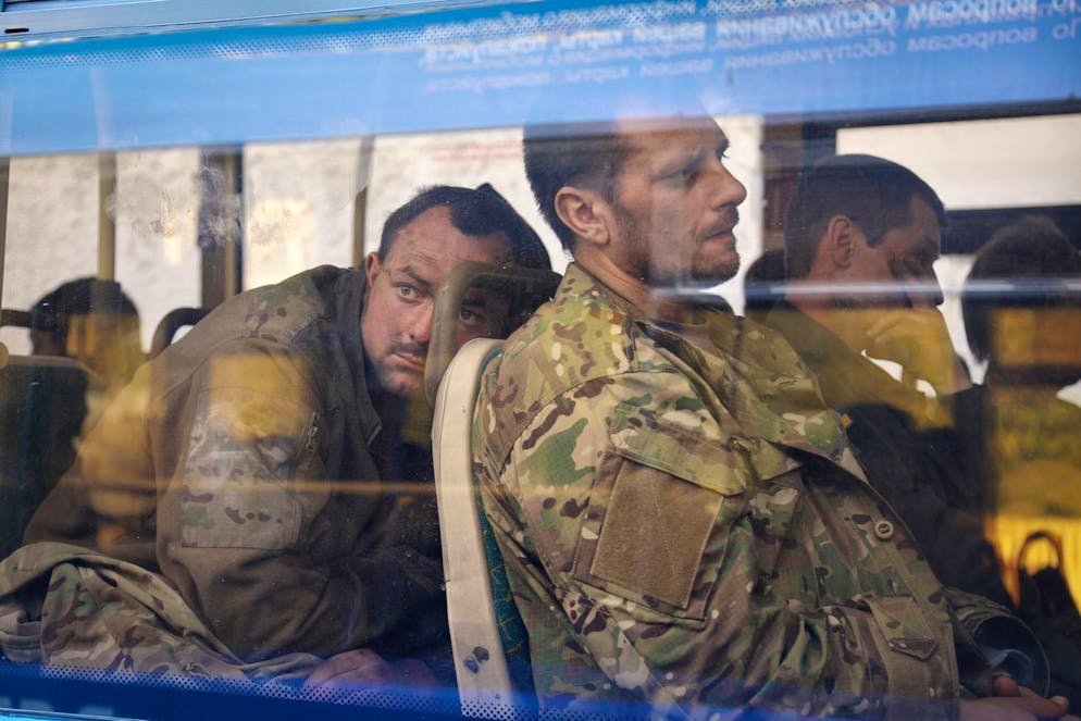 FILE - Ukrainian servicemen sit in a bus after they were evacuated from the besieged Mariupol's Azovstal steel plant, near a remand prison in Olyonivka, in territory under the government of the Donetsk People's Republic, eastern Ukraine, Tuesday, May 17, 2022. Breaking its silence on prisoners of war, the Red Cross said Thursday, May 19, 2022 it has registered âÄœhundredsâÄ of Ukrainian prisoners of war who left the giant Azovstal steel plant in Mariupol after holding out in a weeks-long standoff with besieging Russian forces. (AP Photo/Alexei Alexandrov, File)