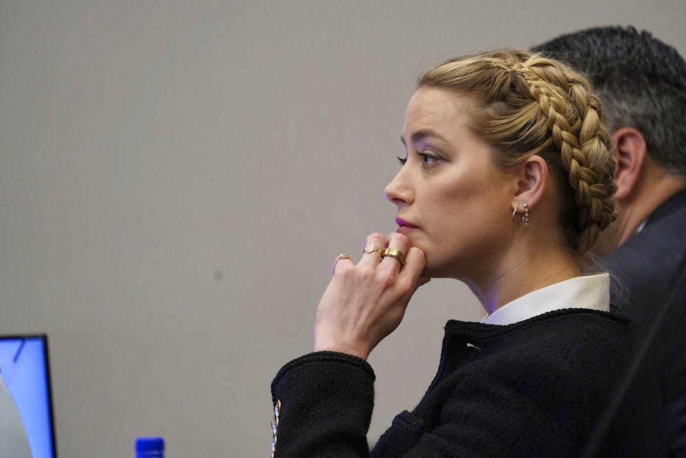 Actor Amber Heard listens in the courtroom at the Fairfax County Circuit Courthouse in Fairfax, Va., Thursday, May 19, 2022. Actor Johnny Depp sued his ex-wife Amber Heard for libel in Fairfax County Circuit Court after she wrote an op-ed piece in The Washington Post in 2018 referring to herself as a 