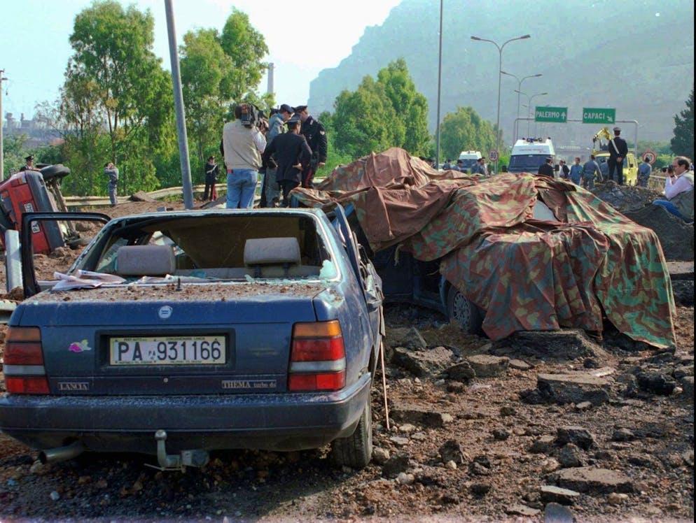 FILE - This May 23, 1992 file photo shows the scene on the highway near the Sicilian town of Palermo, southern Italy, after a powerful bomb killed anti-Mafia magistrate Giovanni Falcone, his wife and three bodyguards. Italian media reported Friday, Nov. 17, 2017 that Mafia boss Salvatore 'Toto' Riina died at the age of 87 in the hospital while serving multiple life sentences as the mastermind of a bloody strategy to assassinate Italian prosecutors and law enforcement trying to bring down the Cosa Nostra. (AP Photo/Bruno Mosconi, files)
