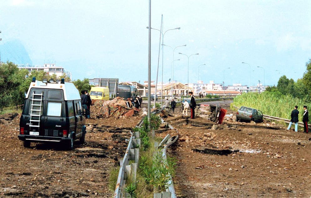 FILE - This May 24, 1992 file photo shows the damage at a highway that links Palermo to its airport a day after a bomb blast killed anti-Mafia prosecutor Giovanni Falcone, his wife and three policemen escorting them. Italian media reported Friday, Nov. 17, 2017 that Mafia boss Salvatore 'Toto' Riina died at the age of 87 in the hospital while serving multiple life sentences as the mastermind of a bloody strategy to assassinate Italian prosecutors and law enforcement trying to bring down the Cosa Nostra. (AP Photo/Nino Labruzzo, files)