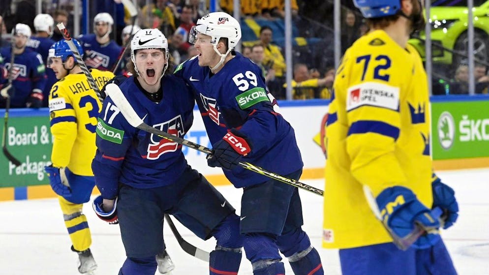 Sweden's Lucas Wallmark, left, and Emil Bemstroem, right, react as United States' Adam Gaudette, 2nd left, and Ben Meyers celebrate their team's opening goal during the group A Hockey World Championship match B match between The United States and Sweden in Tampere, Finland, Friday, May 21, 2022. (Heikki Saukkomaa/Lehtikuva via AP)