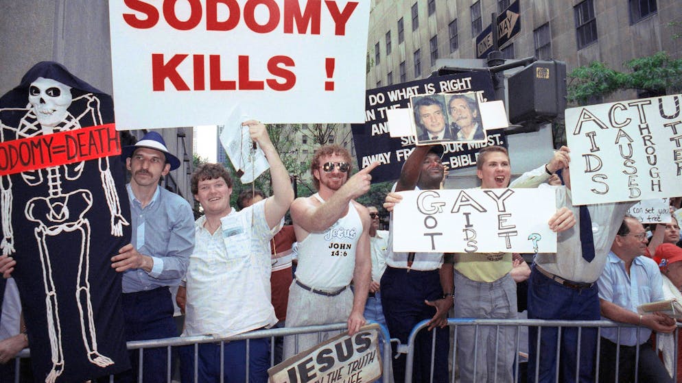 FILE - In this Sunday, June 25, 1990 file photo, anti-gay protesters heckle marchers in the Gay Pride Parade along Fifth Avenue in New York. About 200,000 people marched in the 21st annual gay and lesbian parade in Manhattan demanding better AIDS treatment and civil rights. (AP Photo/David A. Cantor)