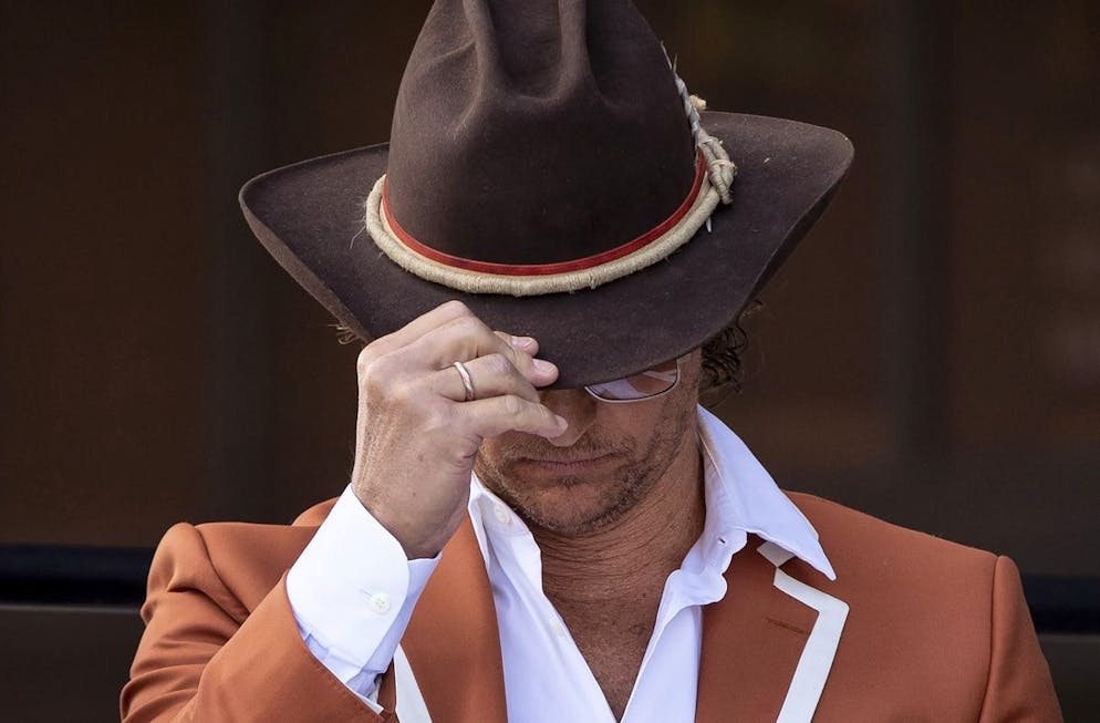 University of Texas Minister of Culture Matthew McConaughey, adjusts his hat at a ribbon cutting ceremony for the Moody Center, a multi-purpose arena that will be home to concerts and the UT basketball teams in Austin, Texas, Tuesday April 19, 2022. (Jay Janner/Austin American-Statesman via AP)