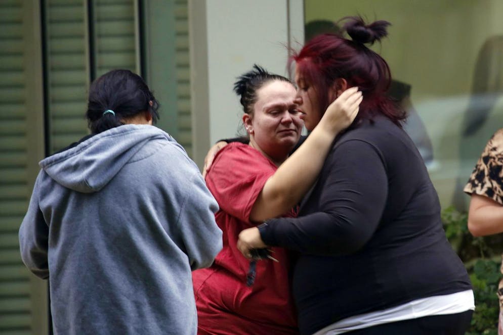 People react outside the Civic Center in Uvalde, Texas, Tuesday, May 24, 2022. An 18-year-old gunman opened fire at a Texas elementary school, killing multiple people. Gov. Greg Abbott says the gunman entered Robb Elementary School in Uvalde with a handgun and possibly a rifle. (AP Photo/Dario Lopez-Mills)