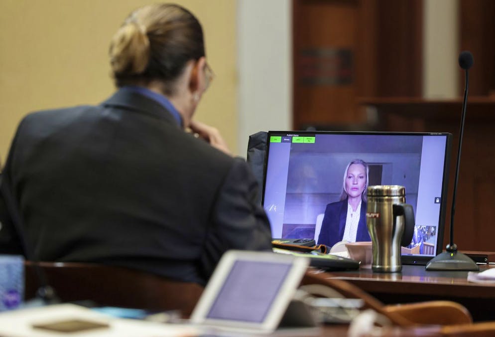 Model Kate Moss, a former girlfriend of actor Johnny Depp, testifies via video link at the Fairfax County Circuit Courthouse in Fairfax, Va., Wednesday, May 25, 2022, as Depp looks on. Depp sued his ex-wife Amber Heard for libel in Fairfax County Circuit Court after she wrote an op-ed piece in The Washington Post in 2018 referring to herself as a 