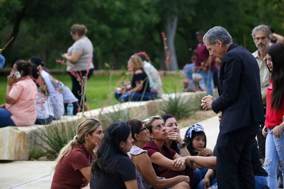 The Archbishop of San Antonio, Gustavo GARCIA SILLER, right, comforts families outside of the Civic Center following a deadly school shooting at Robb Elementary School, in Uvalde, Texas Tuesday, May 24, 2022. (AP Photo/Dario Lopez-Mills)
