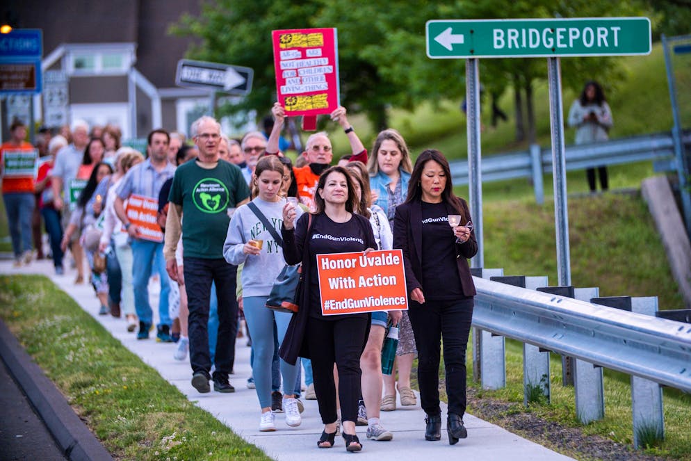 People march along a local street at the end of a vigil to stand in solidarity with the Uvalde, Texas, families and demand an end to gun violence on Thursday, May 26, 2022, in Newtown, Conn. (AP Photo/Eduardo Munoz Alvarez)