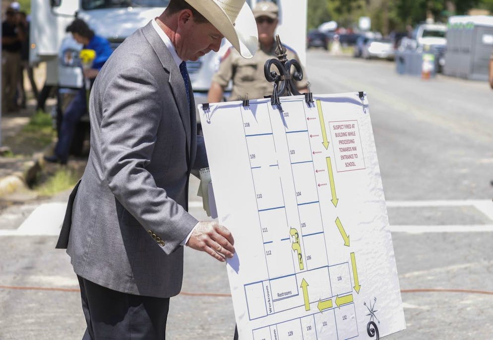 epa09980703 A law enforcement officer displays a graphic showing the route taken by gunman Salvador Ramos into Robb Elementary School in Uvalde, Texas, USA, 27 May 2022. According to Texas officials, at least 19 children and two adults were killed in the shooting on 24 May. The eighteen-year-old gunman was killed by responding officers. EPA/TANNEN MAURY