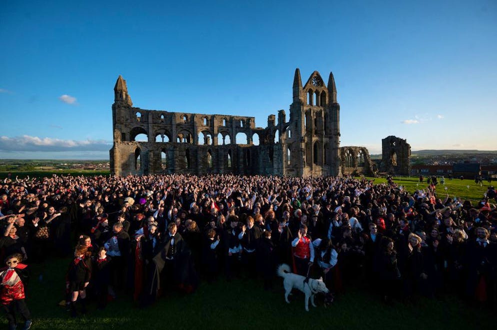 TOPSHOT - Vampires gather in the grounds of Whitby Abbey during a Guinness world record attempt to gather the largest number of vampires together in one place, in Whitby, north-east England on May 26, 2022. - The world record attempt took place on the 125th anniversary of the first publication of Bram Stoker's novel 'Dracula'. Stoker visited Whitby in 1890 and it's understood that the town and 13th century gothic ruins of the Abbey provided inspiration for Dracula. The current record saw 1039 vampires gather at Doswell in Virginia, USA in 2011. (Photo by OLI SCARFF / AFP) (Photo by OLI SCARFF/AFP via Getty Images)