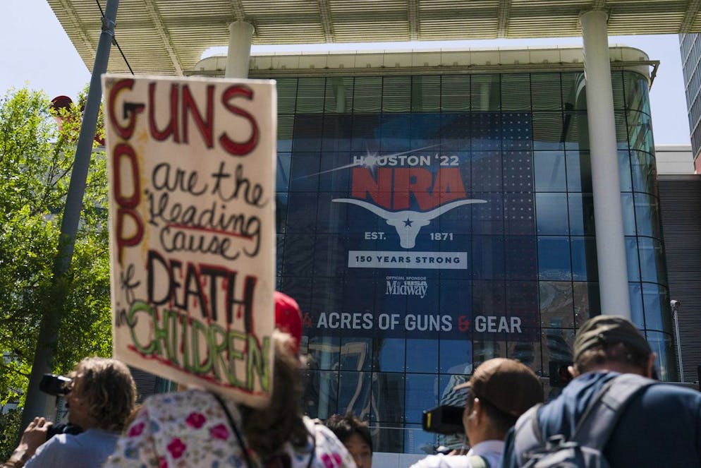 People gather outside the George R. Brown Convention Center to protest the National Rifle Association's annual meeting in Houston, Friday, May 27, 2022. (AP Photo/Jae C. Hong)