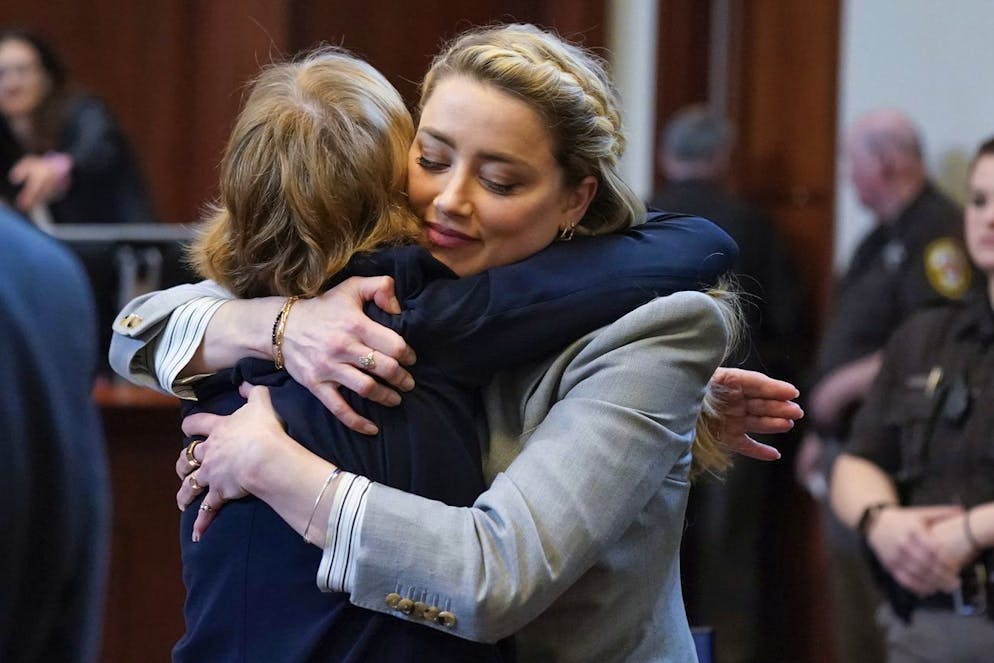 Actor Amber Heard hugs her attorney Elaine Bredehoft after closing arguments at the Fairfax County Circuit Courthouse in Fairfax, Va., Friday, May 27, 2022. Actor Johnny Depp sued his ex-wife Amber Heard for libel in Fairfax County Circuit Court after she wrote an op-ed piece in The Washington Post in 2018 referring to herself as a 