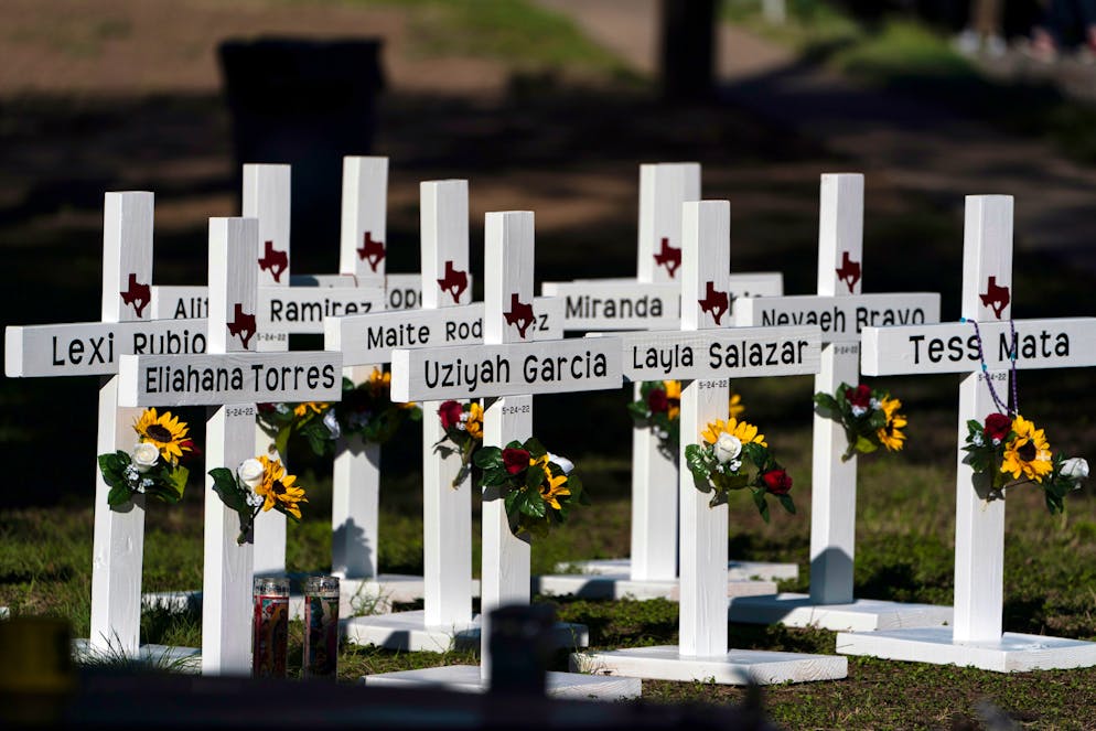 Crosses with the names of Tuesday's shooting victims are placed outside Robb Elementary School in Uvalde, Texas, Thursday, May 26, 2022. The 18-year-old man who slaughtered 19 children and two teachers in Texas left a digital trail that hinted at what was to come.  (AP Photo/Jae C. Hong)
