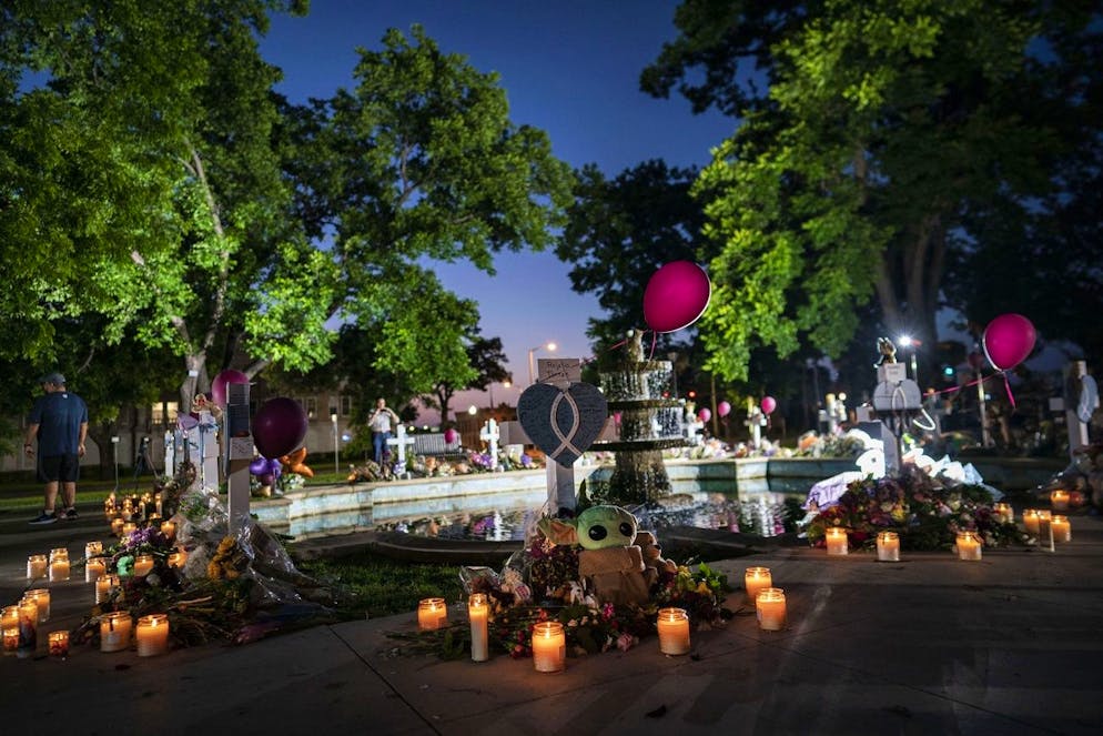 Candles are lit at dawn at a memorial site in the town square for the victims killed in this week's elementary school shooting on Friday, May 27, 2022, in Uvalde, Texas. (AP Photo/Wong Maye-E)