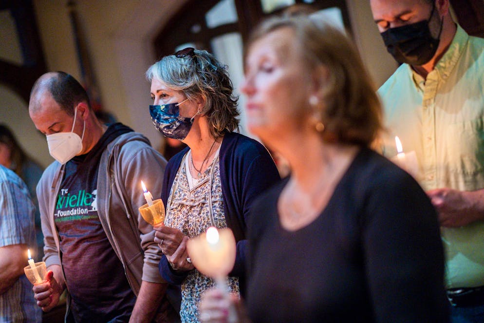 People take part in a vigil to stand in solidarity with the Uvalde, Texas, families and demand an end to gun violence at Trinity Episcopal Church on Thursday, May 26, 2022, in Newtown, Conn. (AP Photo/Eduardo Munoz Alvarez)