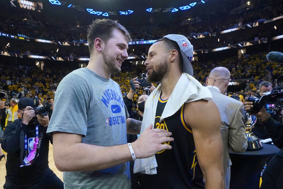 Dallas Mavericks guard Luka Doncic, left, greets Golden State Warriors guard Stephen Curry after the Warriors defeated the Dallas Mavericks in Game 5 of the NBA basketball playoffs Western Conference finals in San Francisco, Thursday, May 26, 2022. (AP Photo/Jeff Chiu)