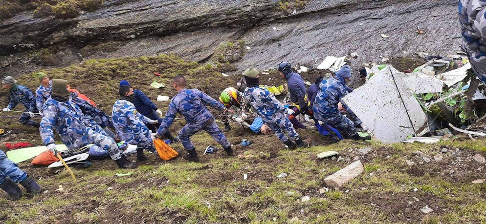 epa09986031 A handout photo made available by the Armed Police Force, Nepal shows rescue team members of the Armed Police force collecting the bodies of the victims at the site of a Tara Air twin engine plane crash, on a cliff at Thasang Village, Mustang District, Nepal, 30 May 2022. On 29 May, a Tara Air plane went missing with 22 people onboard, several minutes after takeoff.  EPA/ARMED POLICE FORCE NEPAL HANDOUT -- BEST QUALITY AVAILABLE -- ATTENTION EDITORS: GRAPHIC CONTENT -- HANDOUT EDITORIAL USE ONLY/NO SALES