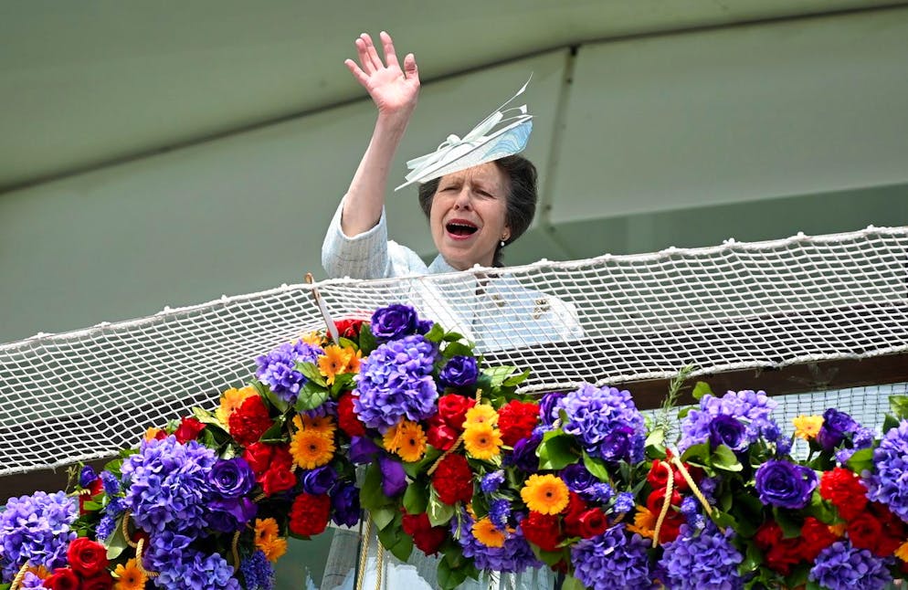 epa09995406 Britain's Princess Anne waves at the Queen's former and current jockeys at Epsom Downs racecourse during Derby Day in London, Britain, 04 June 2022. Britain is enjoying a four day holiday weekend to celebrate the Platinum Jubilee of Britain's Queen Elizabeth II marking the 70th anniversary of her accession to the throne on 06 February 1952. EPA/ANDY RAIN
