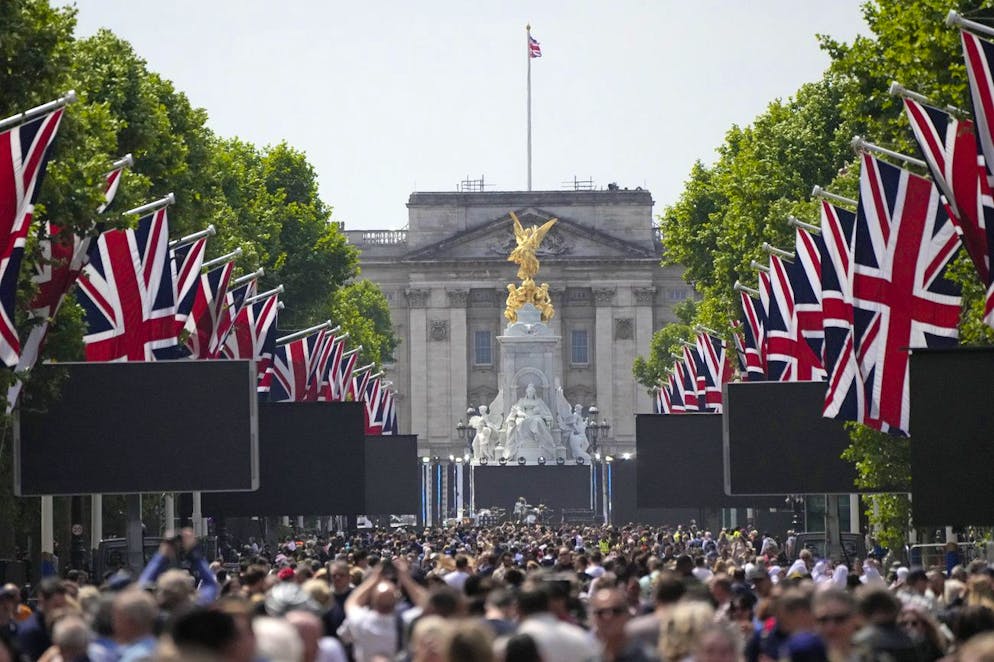 People gather on the Mall near Buckingham Palace, London, Saturday June 4, 2022 ahead of the Platinum Jubilee concert, on the third of four days of celebrations to mark the Platinum Jubilee. The events over a long holiday weekend in the U.K. are meant to celebrate Queen Elizabeth II's 70 years of service. (AP Photo/Frank Augstein)