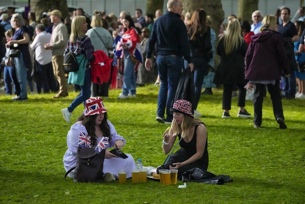 Royal fans have something to eat and drink prior to the Platinum Jubilee concert which takes place in front of Buckingham Palace, London, Saturday June 4, 2022, on the third of four days of celebrations to mark the Platinum Jubilee. The events over a long holiday weekend in the U.K. are meant to celebrate Queen Elizabeth II's 70 years of service. (AP Photo/Frank Augstein)